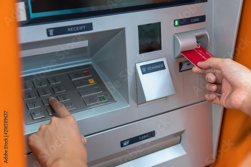 Closeup woman withdrawing the cash via ATM, business Automatic Teller Machine concept