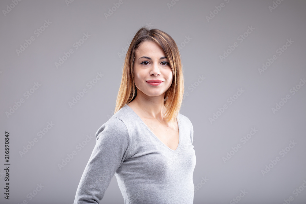 Smiling young woman with brown hair wearing shirt Smiling young woman with brown hair wearing shirt