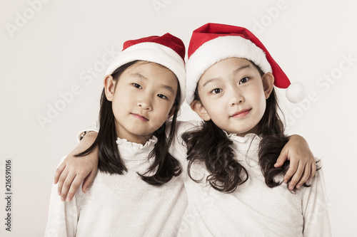 A asian girl portrait with santa hat isolated white.