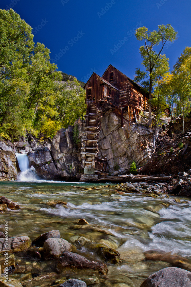Crystal Mill, rustic old building outside Aspen, Colorado with waterfall, rushing stream and fall colors