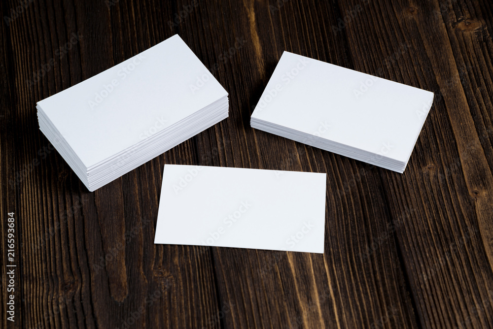 Blank business cards on wooden working table with copy space for add text ID. and logo, business company concept. Blank business cards on wooden working table with copy space for add text ID. and logo, business company concept.