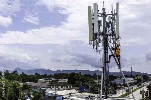 technician installing communication tool on high pole