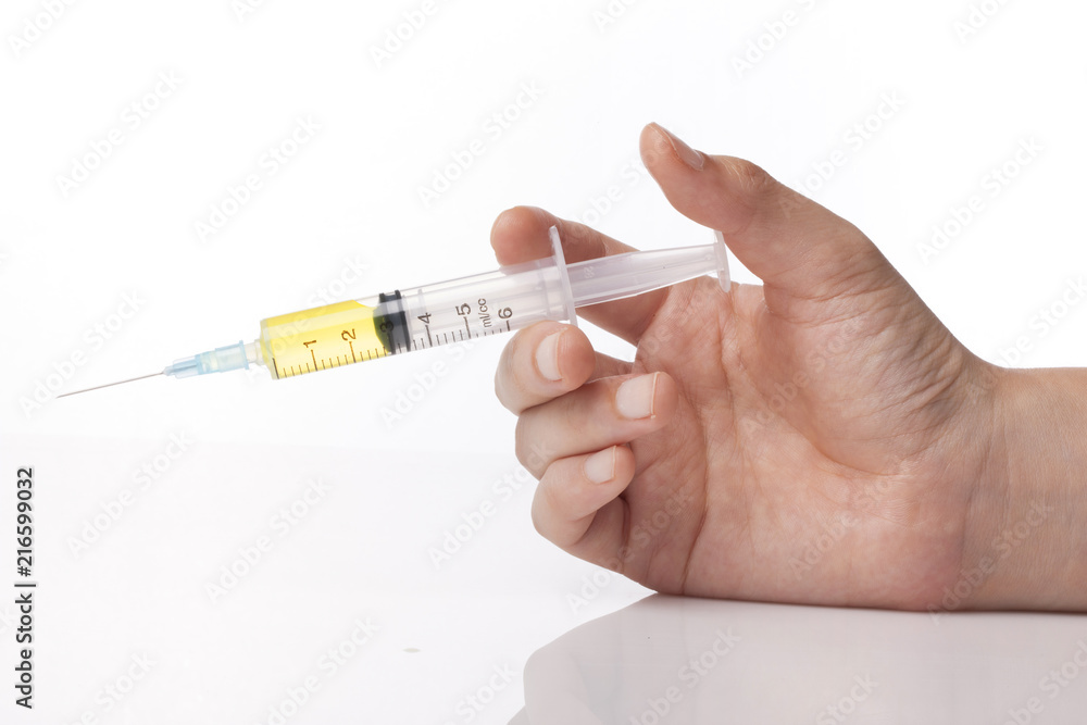 hand hold a syringe isolated white. hand hold a syringe isolated white.