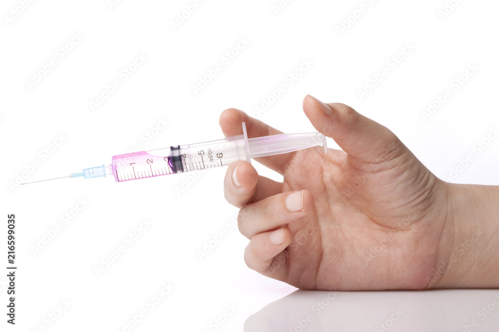 Fototapeta premium hand hold a syringe isolated white.