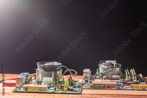 computer mainboard on wooden table on black background photo