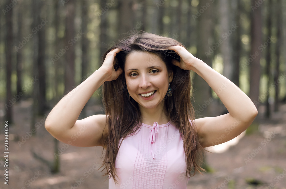 Young happy woman posing in the forest.