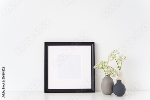 Black portrait square frame mock up with a episcopal weed in little vases. Mockup for quote, promotion, headline, design. Template for small businesses, lifestyle bloggers, social media photo