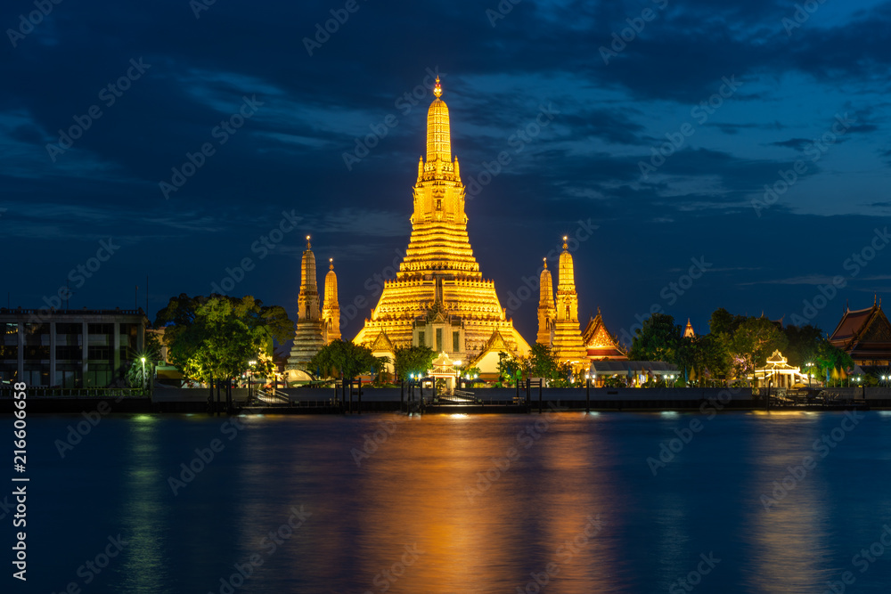Wat Arun Temple beside Chao Phraya River at twilight time in Bangkok, Thailand. One of the most famous place of Thailand's landmarks. Light reflection on smooth water. Wat Arun Temple beside Chao Phraya River at twilight time in Bangkok, Thailand. One of the most famous place of Thailand's landmarks. Light reflection on smooth water.