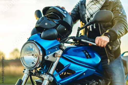 Man on sport motorcycle outdoor on the road photo