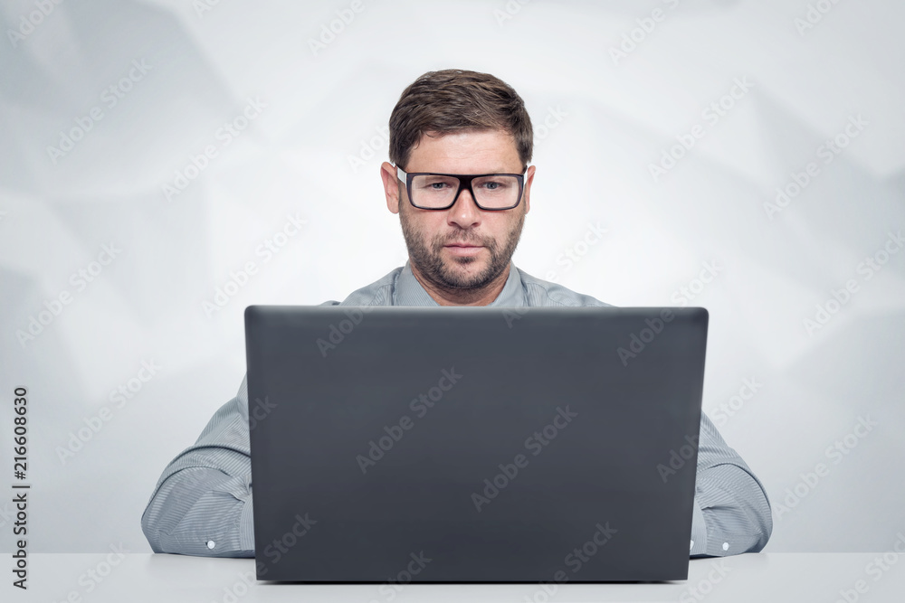 Bearded man with glasses working on laptop Look at the screen. Bearded man with glasses working on laptop Look at the screen.