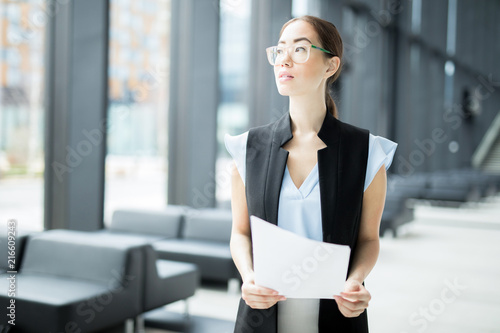 Young pensive businesswoman with papers preparing for conference or business seminar Free Download Young pensive businesswoman with papers preparing for conference or business seminar - GFXLoad