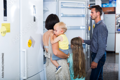 family choosing new fridge