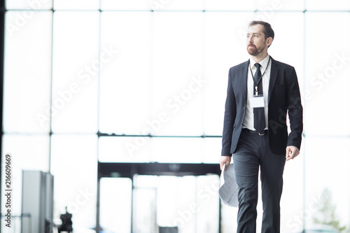 Wallpaper Mural Young man in elegant suit walking inside modern airport after arrival in foreign city for conference Torontodigital.ca