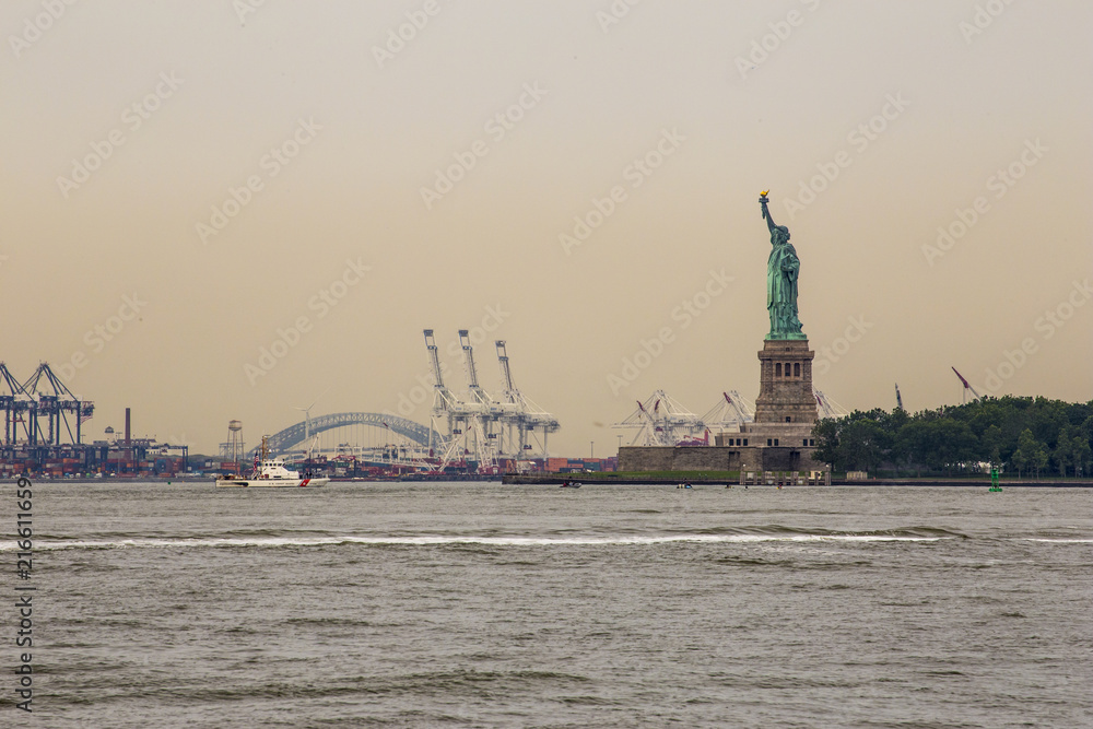 Statue of liberty on Manhattan Harbor at dawn taken from Battery Park a