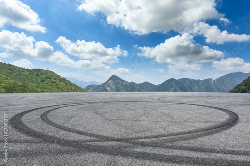Empty asphalt square and mountain scenery under the blue sky