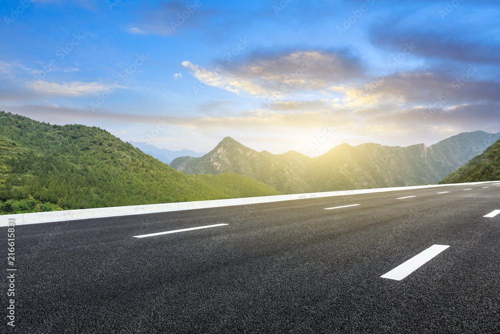 Empty asphalt road and mountains natural scenery at sunrise