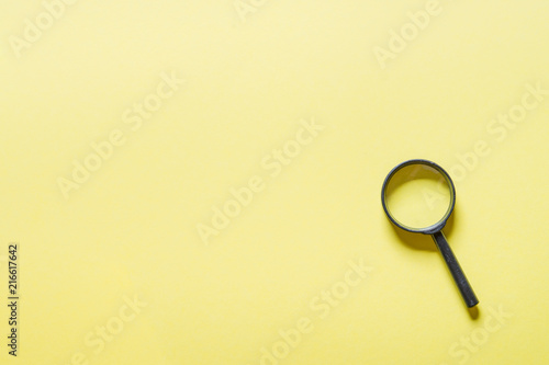 Loupe or magnifier on yellow background. 