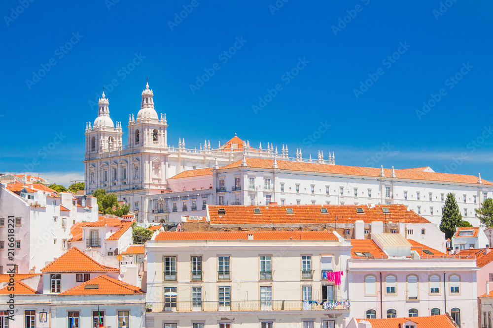 Panorama of ancient Lisbon, Portugal, red tile roofs and monastery Igreja Sao Vicente de Fora, popular tourist destination, beautiful summer day