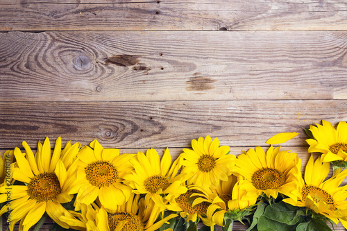 Fototapeta Naklejka Na Ścianę i Meble -  Yellow sunflowers on old wooden background. Copy space.