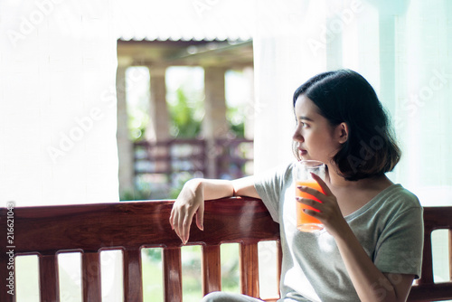 Asian girl relaxing with orange juice