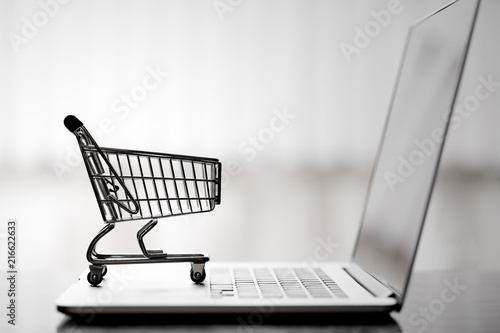 Shopping cart on laptop,online shopping and delivery service concept. photo