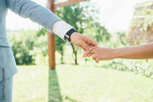 young couple is holding hands