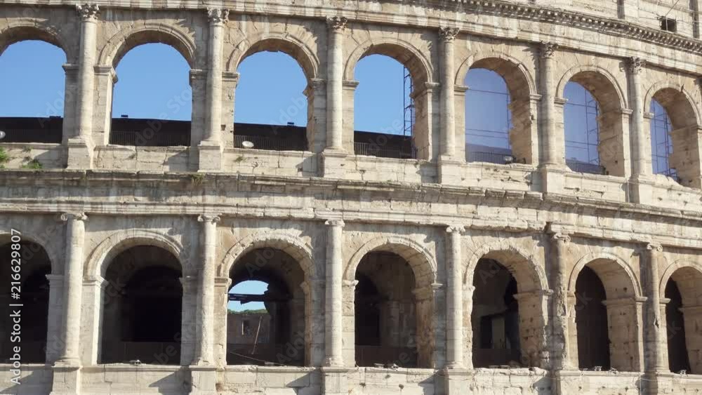 Famous Italian attraction Colosseum in Rome. Veiw on ancient Flavius amphitheater Coliseum in capital of Italy. Camera moving from right to left Famous Italian attraction Colosseum in Rome. Veiw on ancient Flavius amphitheater Coliseum in capital of Italy. Camera moving from right to left