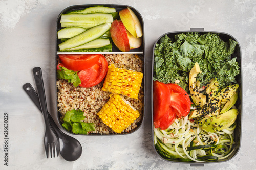 Healthy meal prep containers with quinoa, avocado, corn, zucchini noodles and kale. Takeaway food.