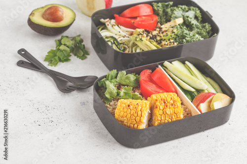 Healthy meal prep containers with quinoa, avocado, corn, zucchini noodles and kale. Takeaway food.