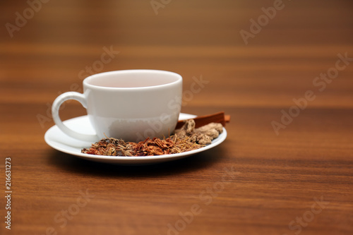 Brewed healthy herbal tea on a wooden background with all dry herbs ingredients. Herbal teas beverage for chinese or thai traditional alternative medicine therapy. 