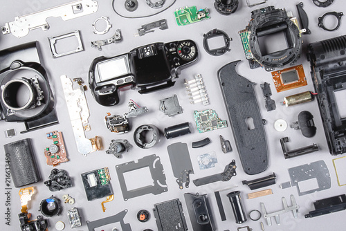 Different parts with a photo camera on a gray background.