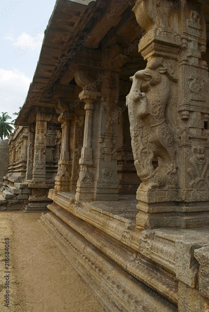 Carved pillars of the inner courtyard, cloisters or pillared verandah and the east gopura. Achyuta Raya temple, Hampi, Karnataka. Sacred Center. View from the east.