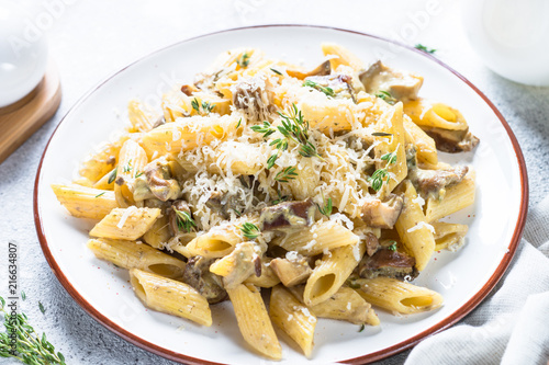 Pasta with white mushrooms in creamy sauce.