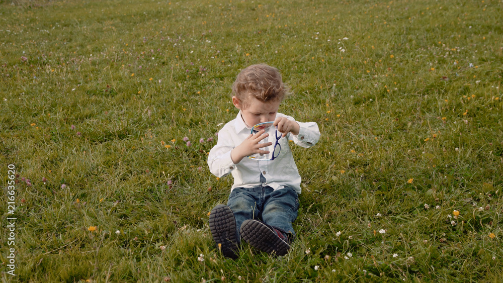 child in glasses on the grass child in glasses on the grass