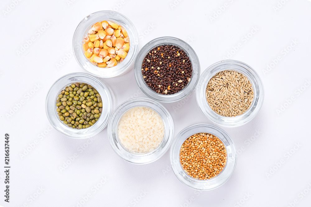Top view of different seeds in glass glasses on a white background Top view of different seeds in glass glasses on a white background