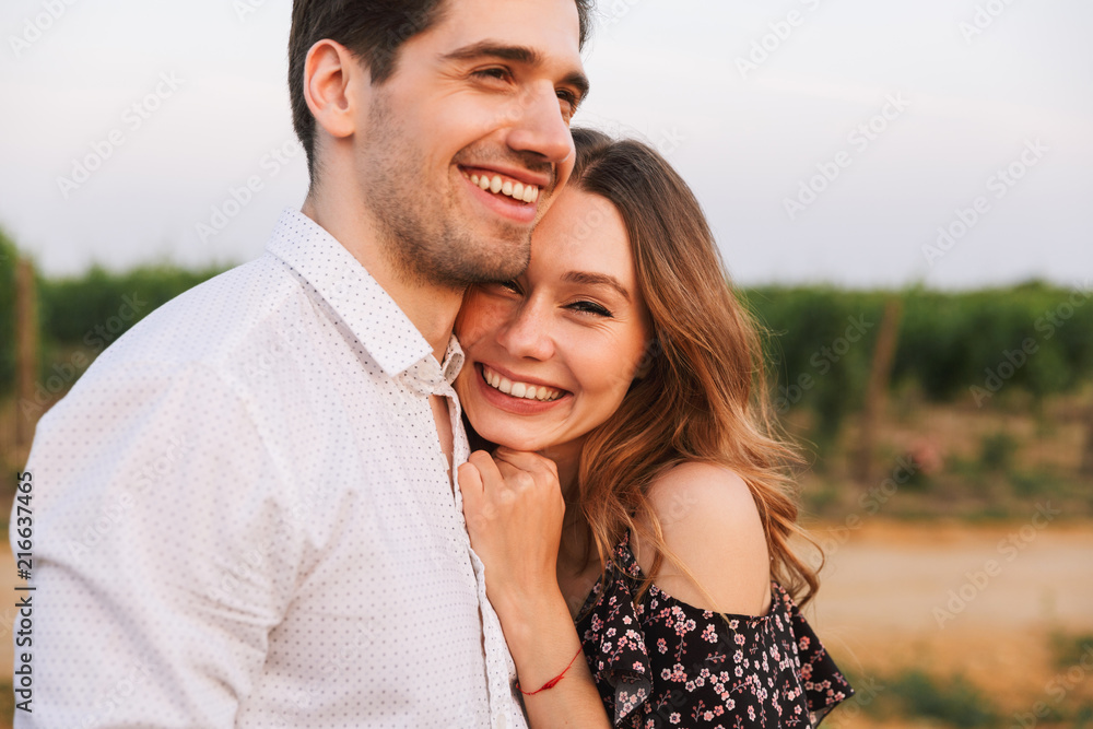 Happy cute loving couple outdoors hugging with each other. Happy cute loving couple outdoors hugging with each other.