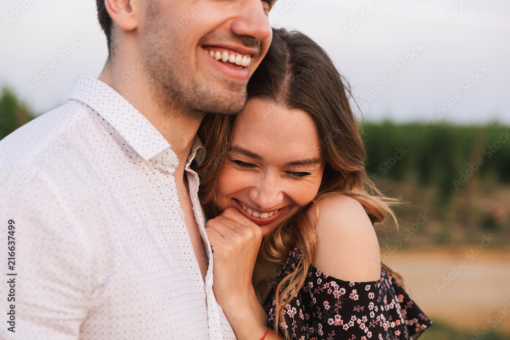 Happy cute loving couple outdoors hugging with each other. Happy cute loving couple outdoors hugging with each other.