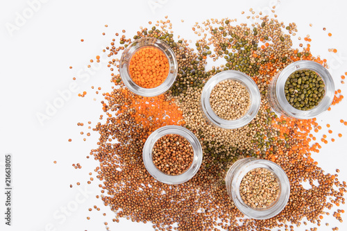 Fototapeta Naklejka Na Ścianę i Meble -  top view of a different beans and seeds near in a glass jar on a white background