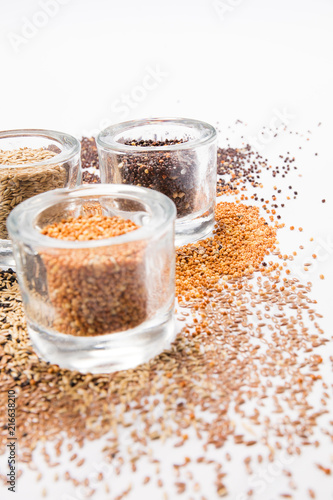 top view of a different beans and seeds near in a glass jar on a white background