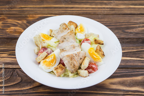 Caesar salad with chicken, in a plate