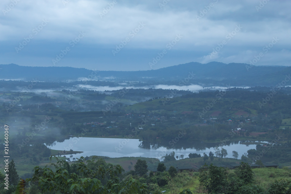Morning mist above the reservoir and the trees at Phetchabun in Thailand.
