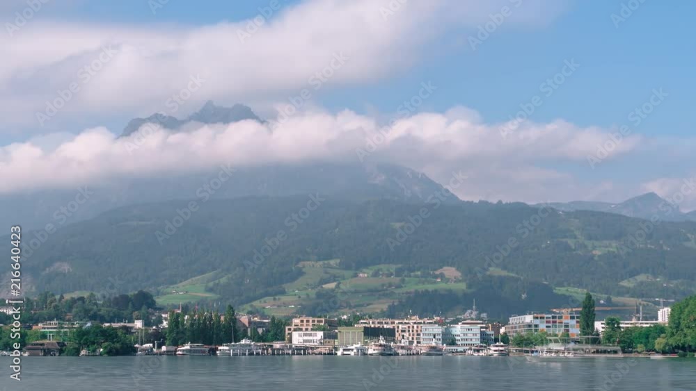 Timelapse of fog and clouds on mountain Pilatus, Switzerland, view from Luzern lake. concept to travel and vacation in Europe, boats, yahts, summer day Timelapse of fog and clouds on mountain Pilatus, Switzerland, view from Luzern lake. concept to travel and vacation in Europe, boats, yahts, summer day