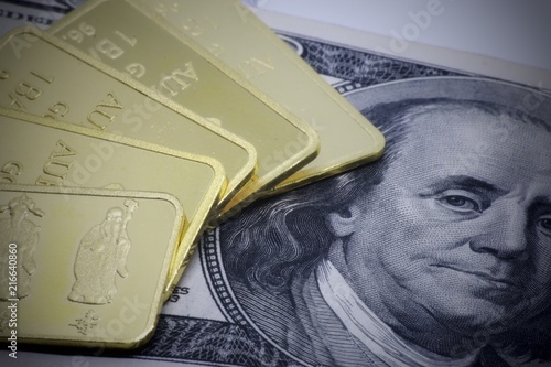 Gold bar ingot close up on the white background ,Gold bar ingot close up on the US money dollar background