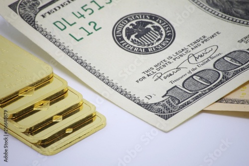 Gold bar ingot close up on the white background ,Gold bar ingot close up on the US money dollar background