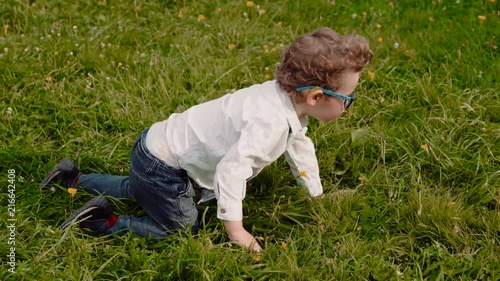 child in glasses on the grass