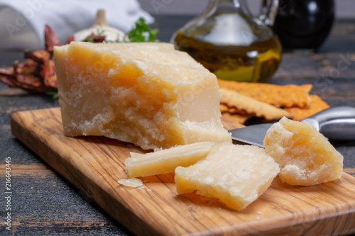 Traditional italian food - 36 months aged in caves Italian parmesan hard cheese from Parmigiano-Reggiano, Italy