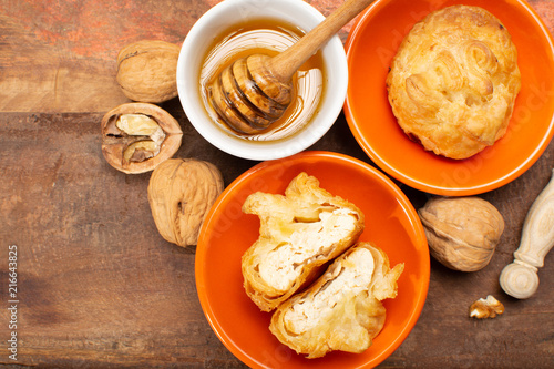 French snack pouches made from puff pastry with fresh soft goat cheese and honing