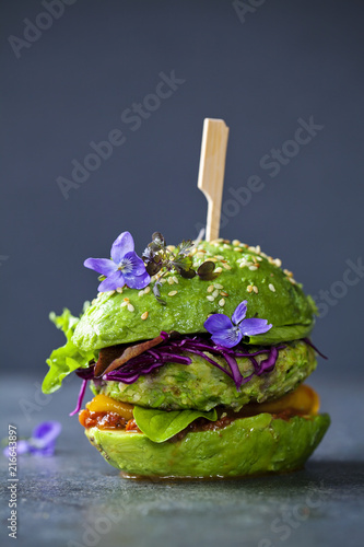 Avocado sandwich with green vegan burger, roast yellow pepper and pickled red cabbage