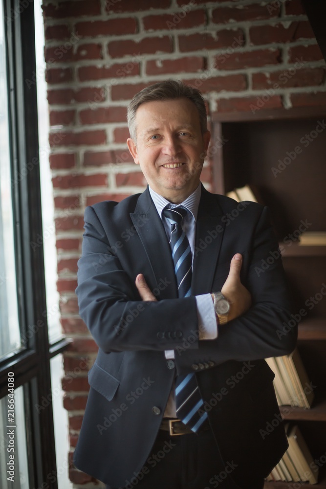 portrait of successful businessman on background of office portrait of successful businessman on background of office