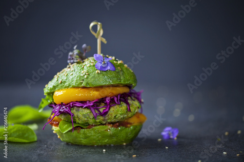 Avocado sandwich with green vegan burger, roast yellow pepper and pickled red cabbage